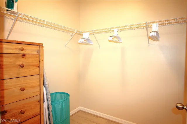 a bedroom with a bed and a tv on the dresser