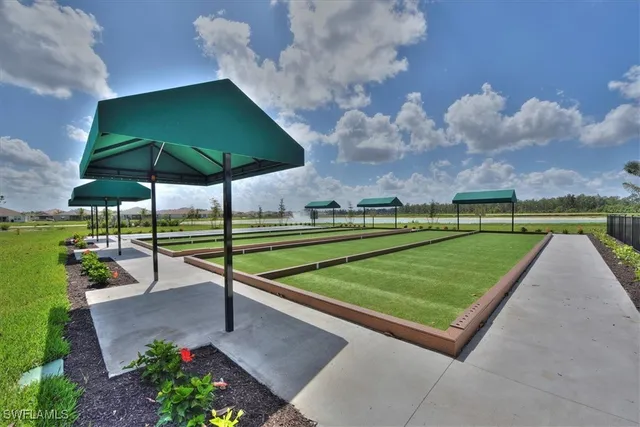 a front view of a house with a yard and potted plants