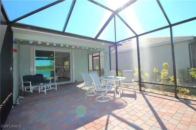 a view of a dining room with furniture a chandelier and wooden floor