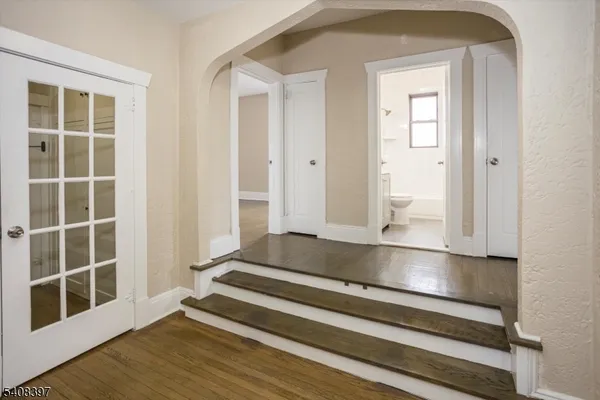 a view of wooden floor and windows in a room
