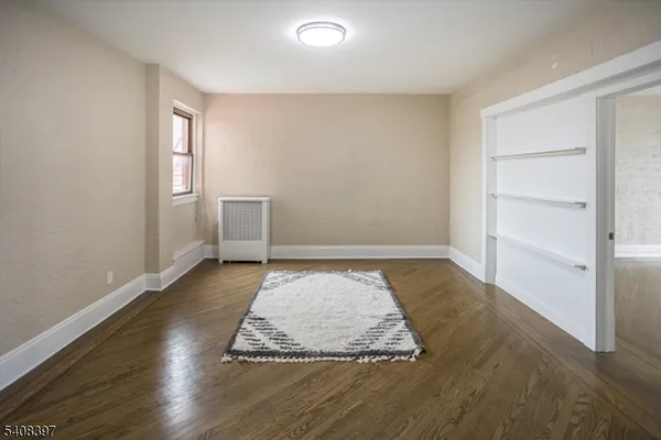 wooden floor with view of empty room