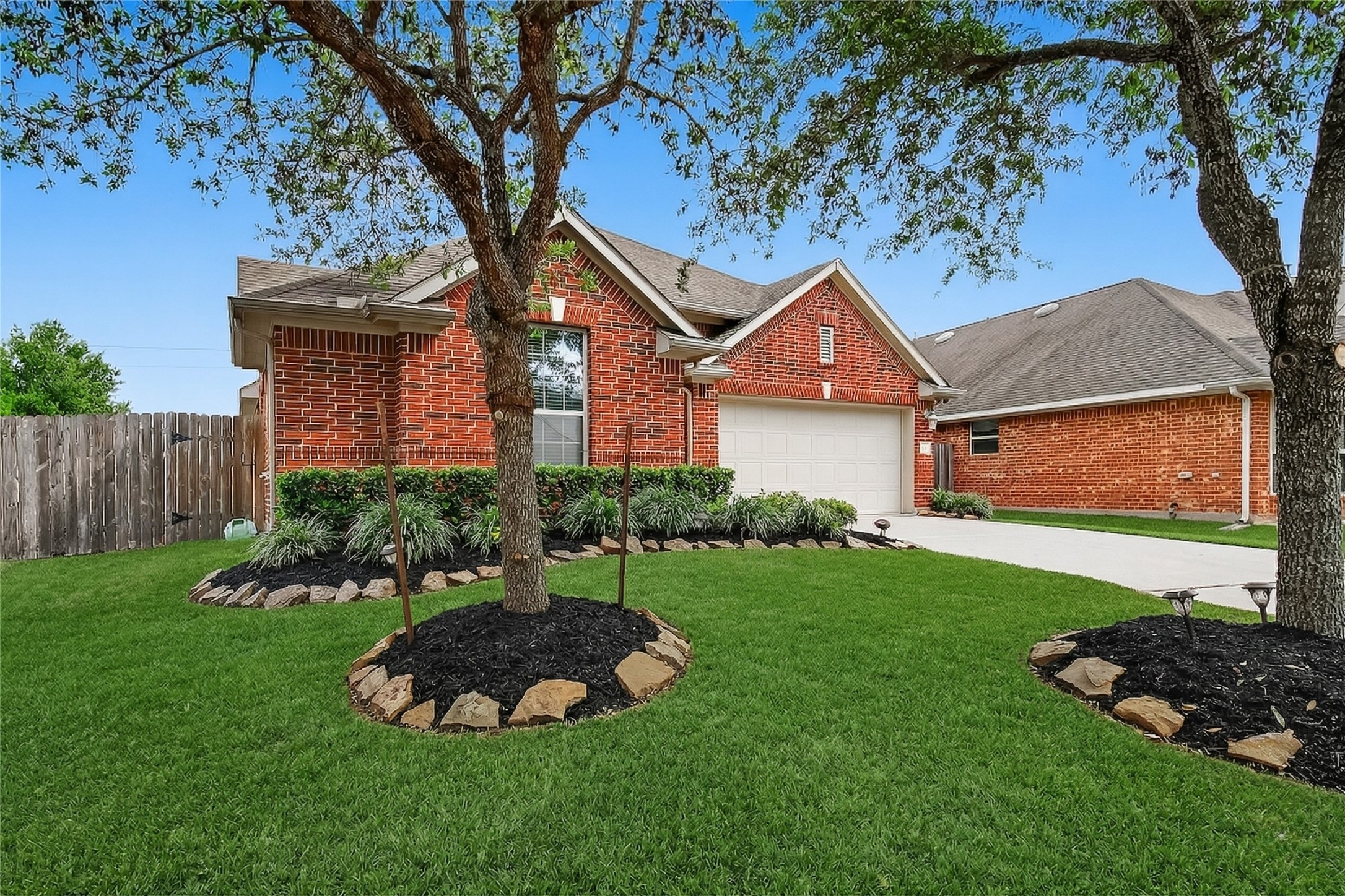 13415 Star Creek Lane Rosharon, TX 77583 - Photo 38 of 46 a front view of a house with a garden and trees