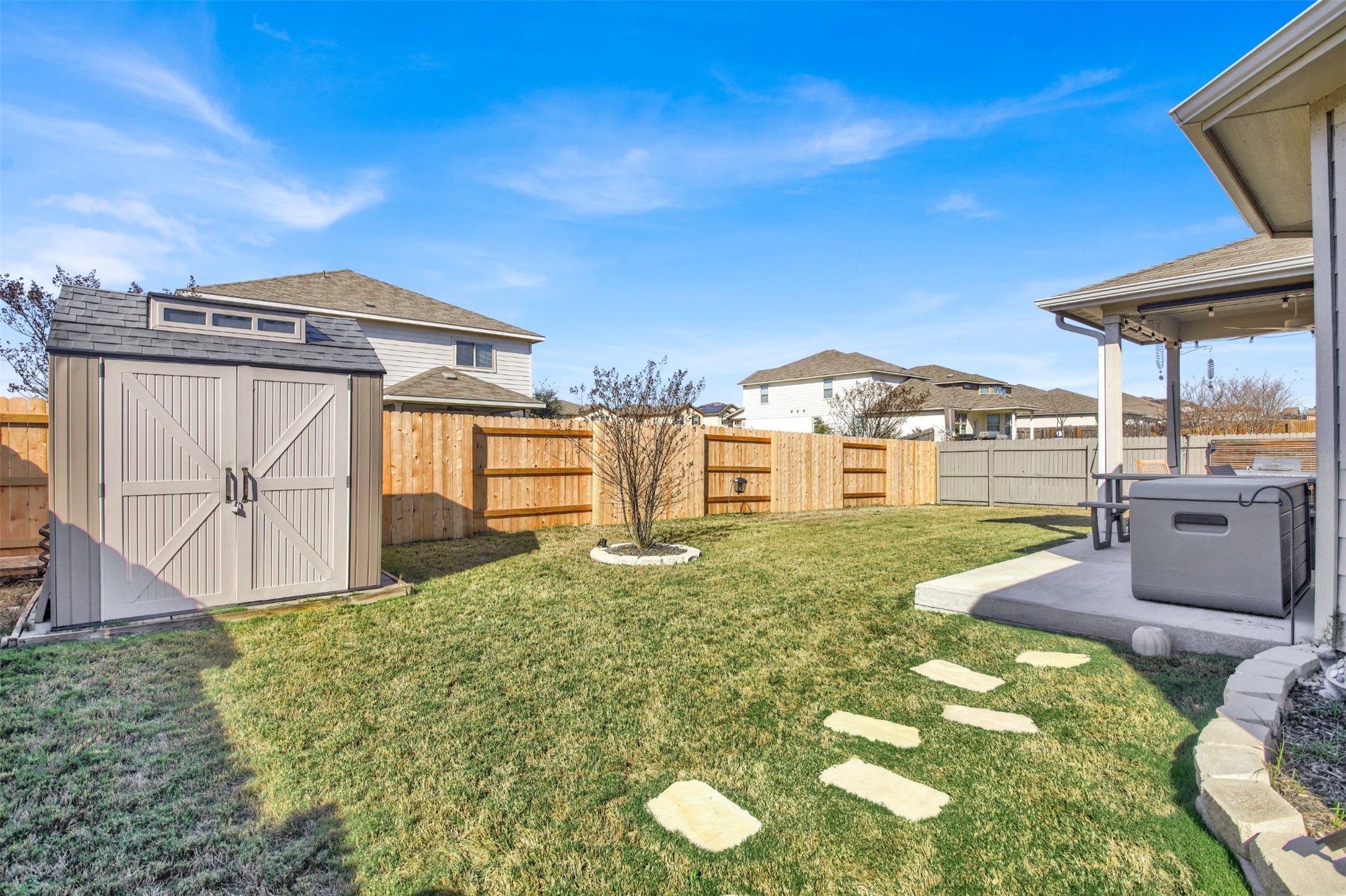 19032 Quebrada Drive Pflugerville, TX 78660 - Photo 26 of 29 Fenced backyard featuring a shed and a patio