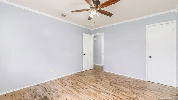 a view of a room with wooden floor