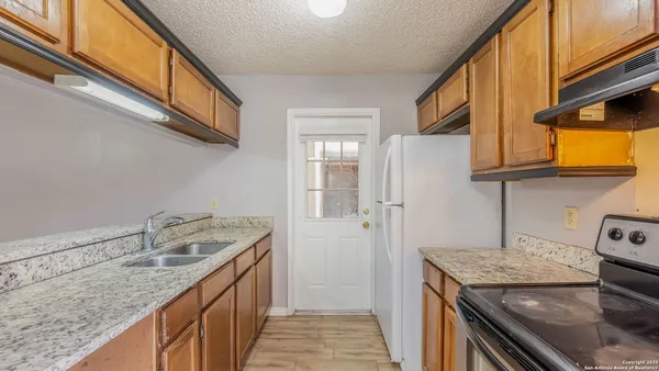 a kitchen with a sink stove and cabinets
