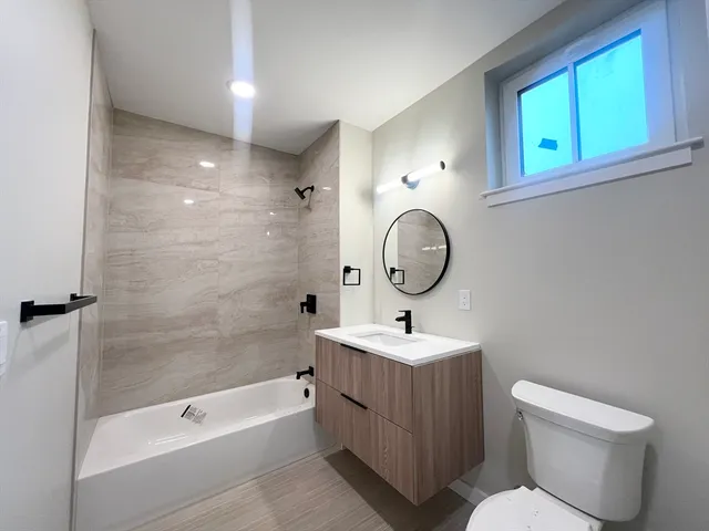 a bathroom with a toilet a sink and a bathtub