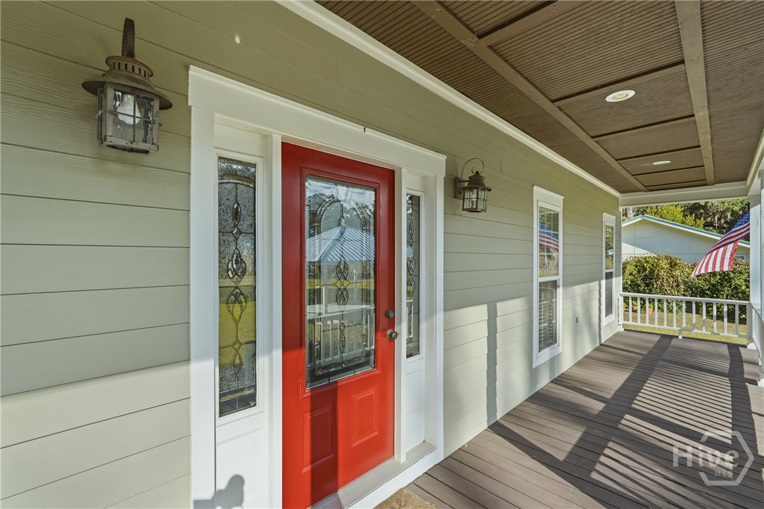 1261 Otter Slide Loop Townsend, GA 31331 - Photo 5 of 47 The front porch stretches across the front of the house.