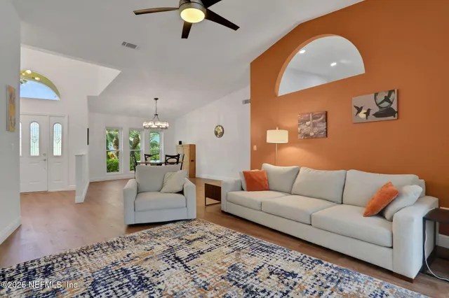 a bathroom with a granite countertop sink vanity and a bathtub
