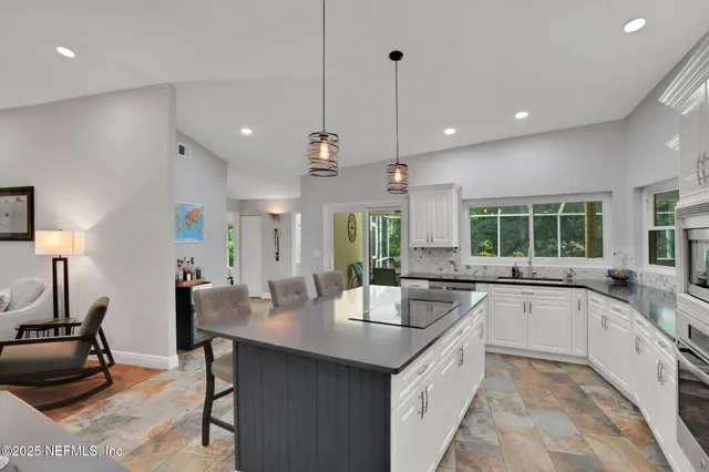 a large kitchen with a table and chairs