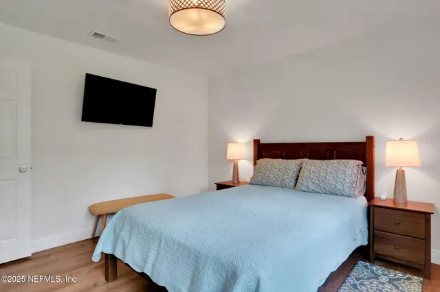 a front view of a house with a garden and yard