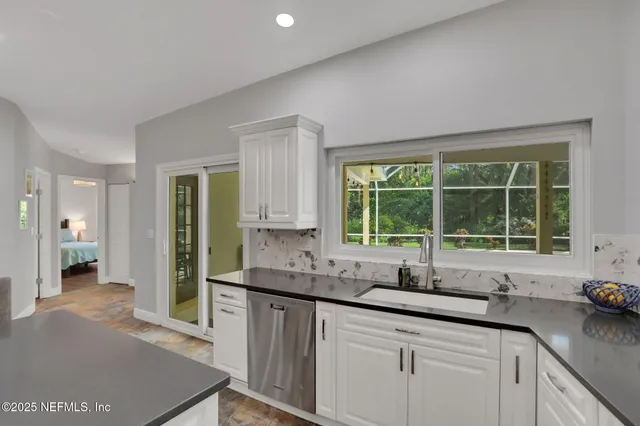 a large kitchen with a table and chairs