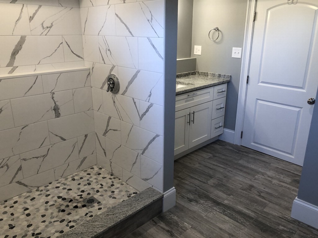 440 Central Avenue, Unit 1 Milton, MA 02186 - Photo 12 of 14 a bathroom with a sink and a mirror