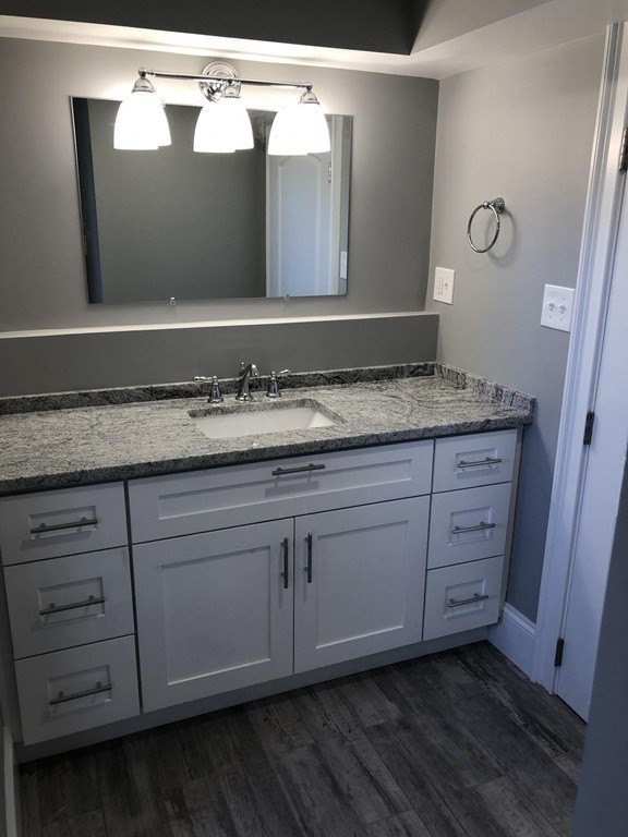 440 Central Avenue, Unit 1 Milton, MA 02186 - Photo 13 of 14 a bathroom with a granite countertop sink and a mirror