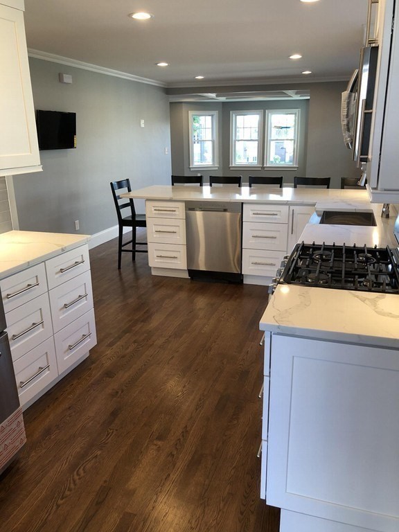 440 Central Avenue, Unit 1 Milton, MA 02186 - Photo 2 of 14 a kitchen with granite countertop a sink a window stainless steel appliances and cabinets