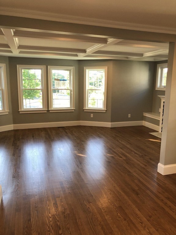 440 Central Avenue, Unit 1 Milton, MA 02186 - Photo 5 of 14 wooden floor in an empty room with a window