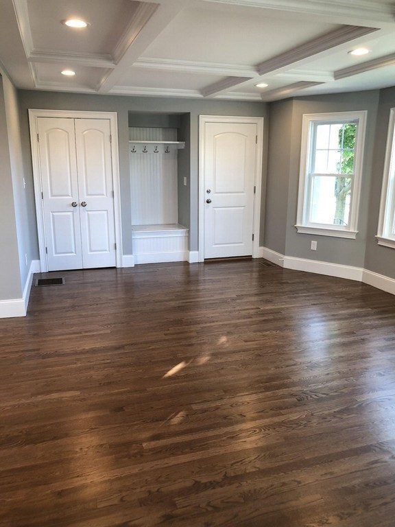 440 Central Avenue, Unit 1 Milton, MA 02186 - Photo 6 of 14 an empty room with wooden floor and windows