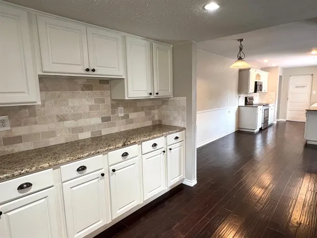 a kitchen with granite countertop white cabinets and a granite counter tops