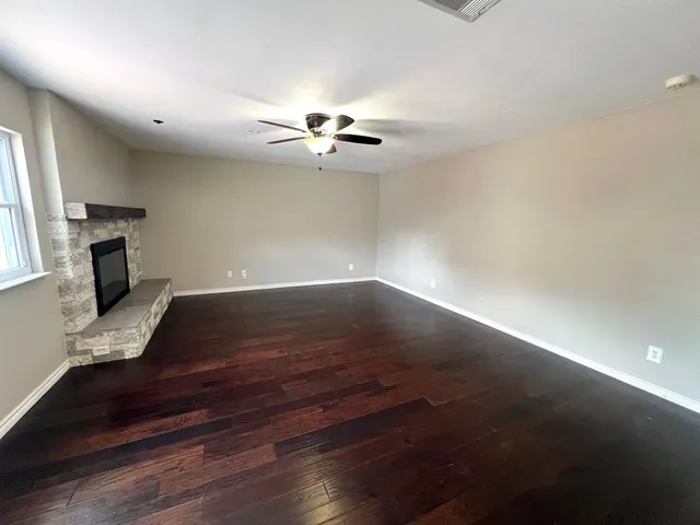 a view of a livingroom with furniture a ceiling fan and a window