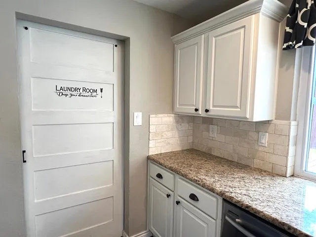 a kitchen with granite countertop cabinets and white appliances