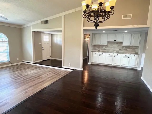 a kitchen with stainless steel appliances granite countertop a wooden floors