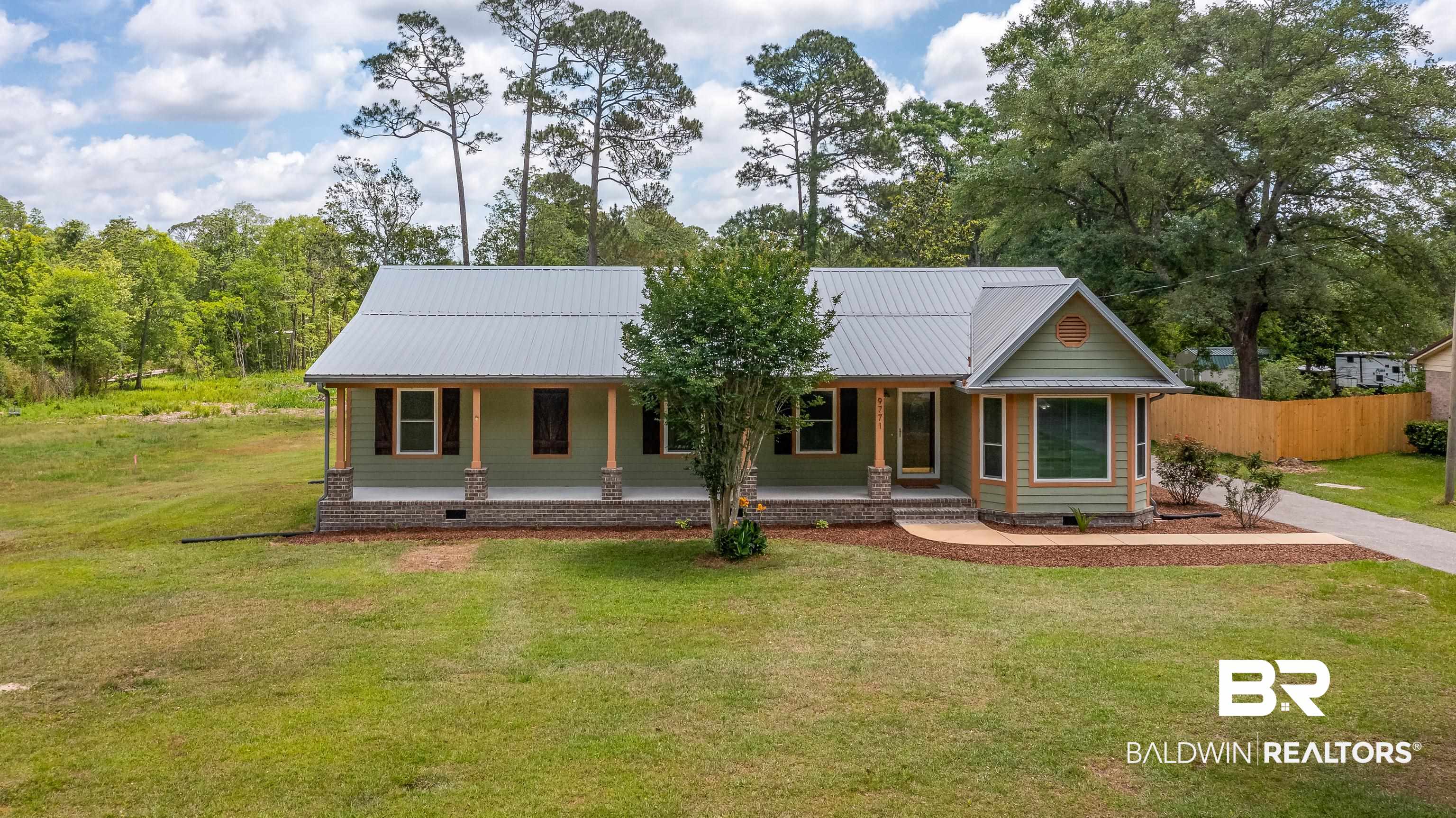 9771 Clarke Ridge Road Foley, AL 36535 - Photo 70 of 72 View of front of property with a front lawn, a porch, and metal roof.