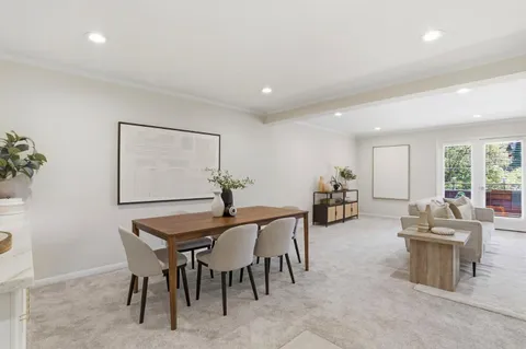a dining room with furniture and wooden floor