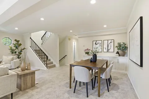 a bathroom with a toilet sink vanity and mirror