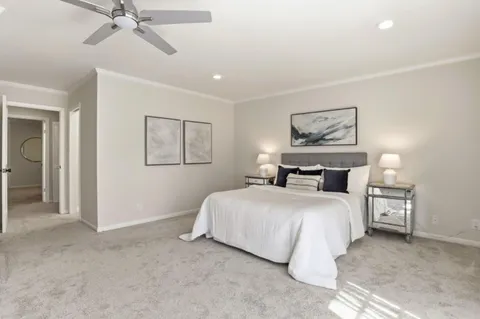 a bedroom with a bed and a painting on the wall