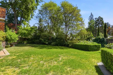 front view of a brick house with a yard