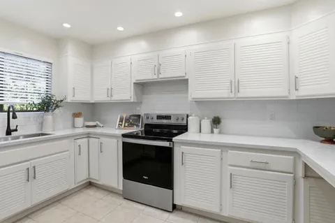 a kitchen with a sink stove and cabinets