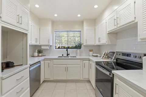 a kitchen with a refrigerator and cabinets