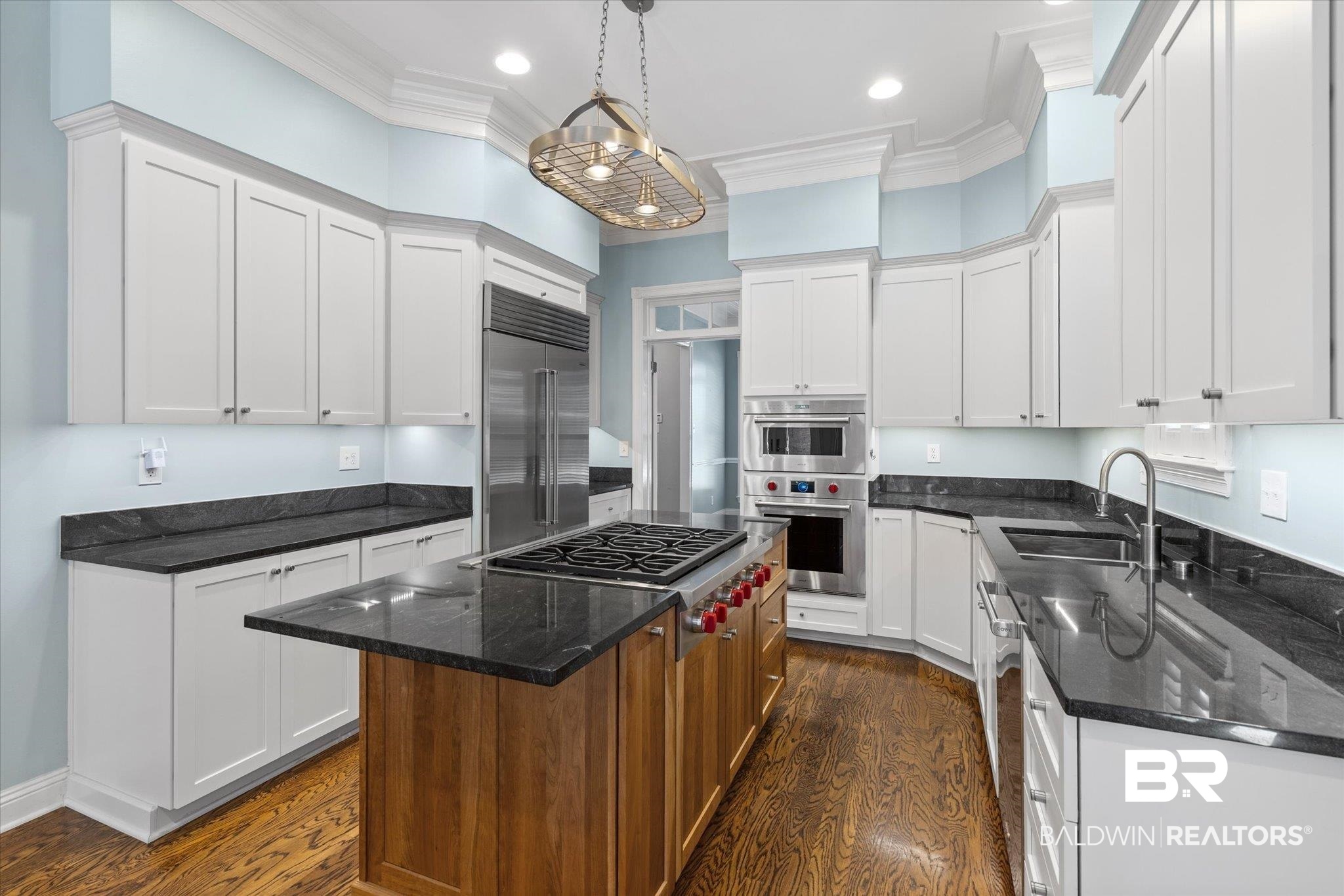 107 Fielding Place Mobile, AL 36608 - Photo 6 of 27 Kitchen featuring a sink, stainless steel appliances, dark wood-style floors, a center island, and white cabinets