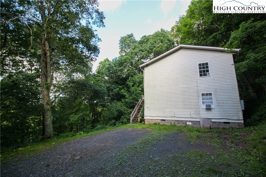 367 Sugarloaf Road Boone, NC 28607 - Photo 3 of 15 a view of a backyard with barn and large trees