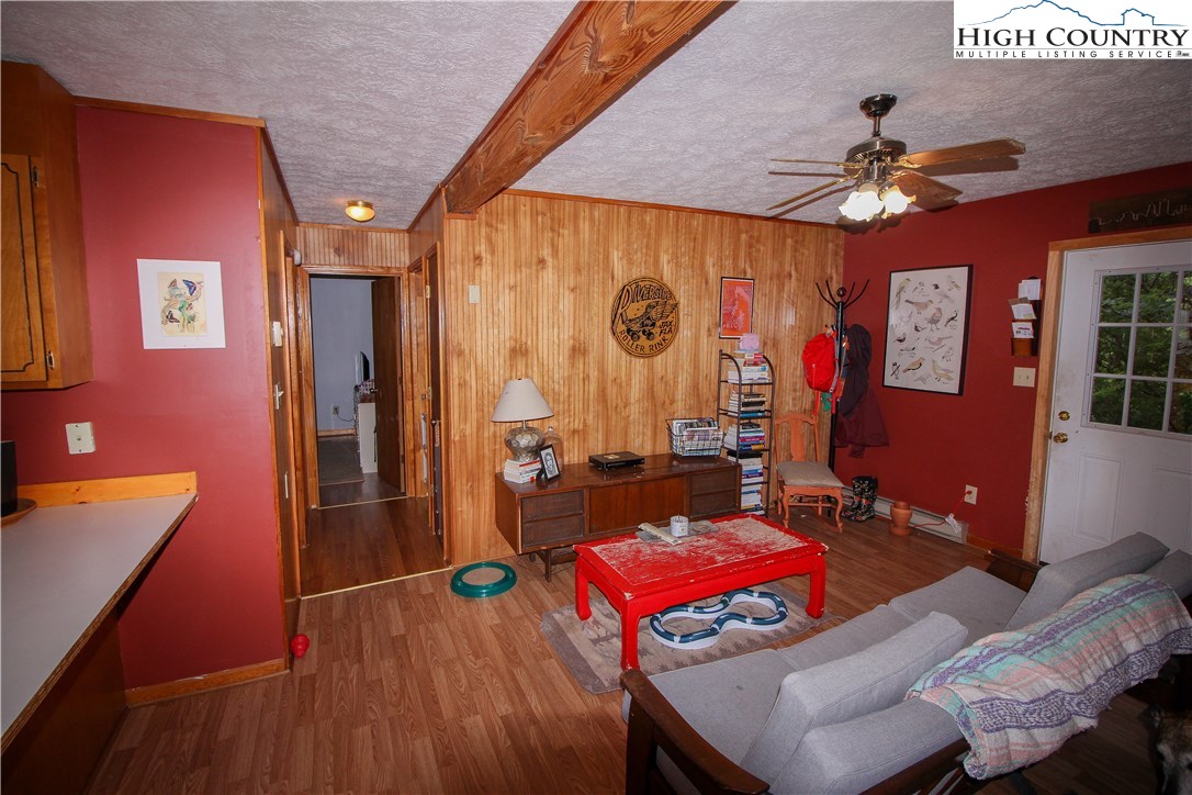 367 Sugarloaf Road Boone, NC 28607 - Photo 8 of 15 a living room with furniture gym equipment and a chandelier