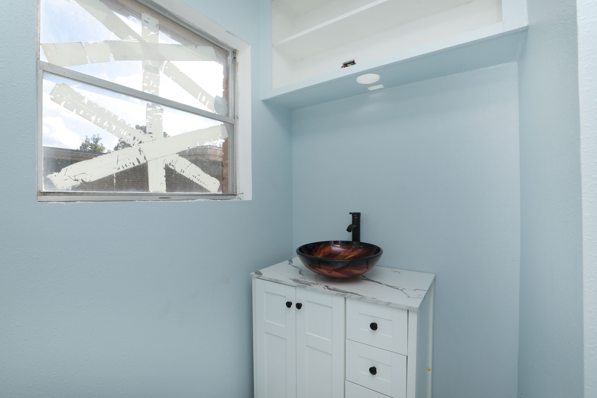 8235 Dover Street Houston, TX 77061 - Photo 27 of 36 a bathroom with a sink and a window