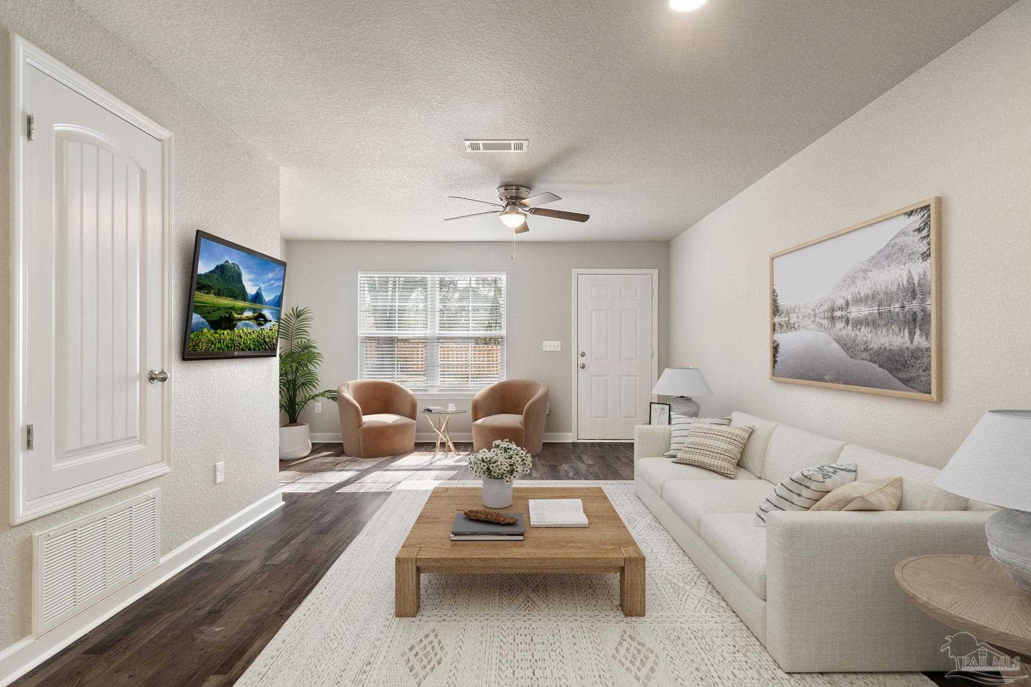 150 South Crow Road, Unit 602 Pensacola, FL 32506 - Photo 2 of 12 a living room with furniture and a flat screen tv