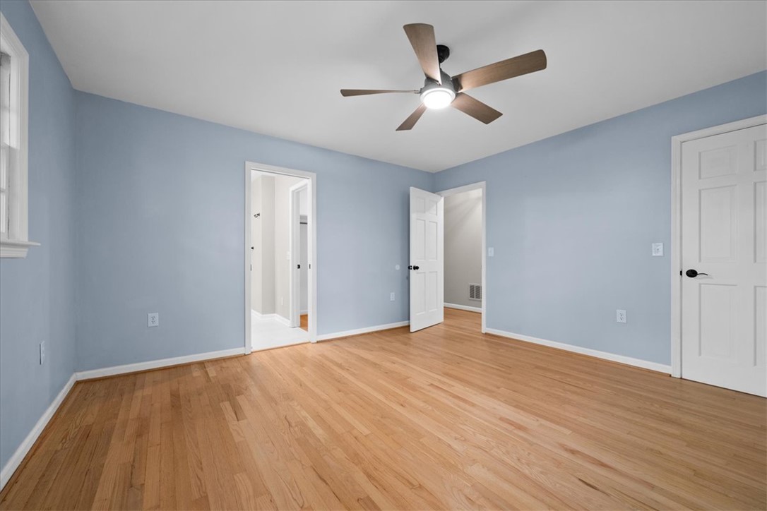 103 Satula Lane Clemson, SC 29631 - Photo 29 of 50 This spacious bedroom features lustrous hardwood flooring, ample natural light, and a cooling ceiling fan.