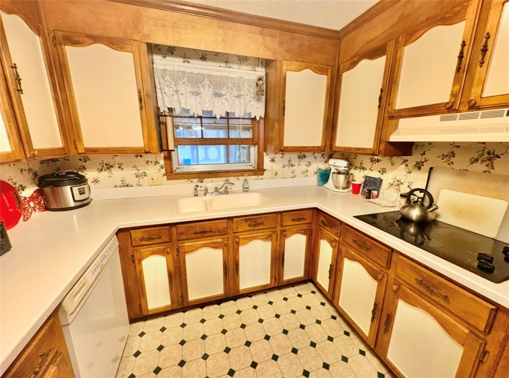 402 Loblolly Drive Anderson, SC 29625 - Photo 13 of 43 This cozy kitchen features abundant wood cabinetry, functional countertops, and a classic tile floor.