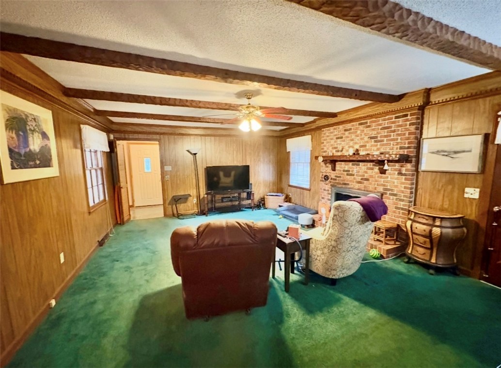 402 Loblolly Drive Anderson, SC 29625 - Photo 15 of 43 This inviting living area features warm wood paneling and a cozy brick fireplace.