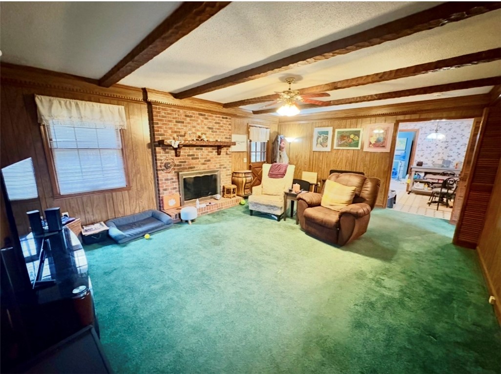 402 Loblolly Drive Anderson, SC 29625 - Photo 16 of 43 This inviting living space features warm wood paneling and a classic brick fireplace.