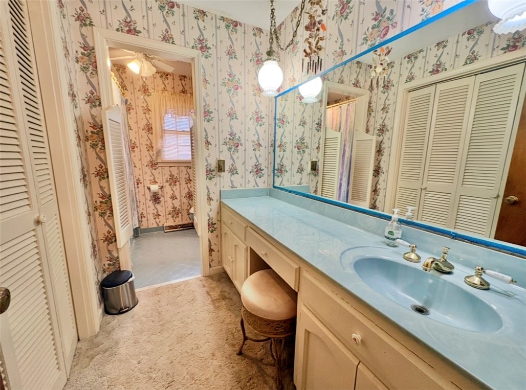 402 Loblolly Drive Anderson, SC 29625 - Photo 27 of 43 This bathroom features a double vanity and ample cabinet space, with an adjacent toilet area.