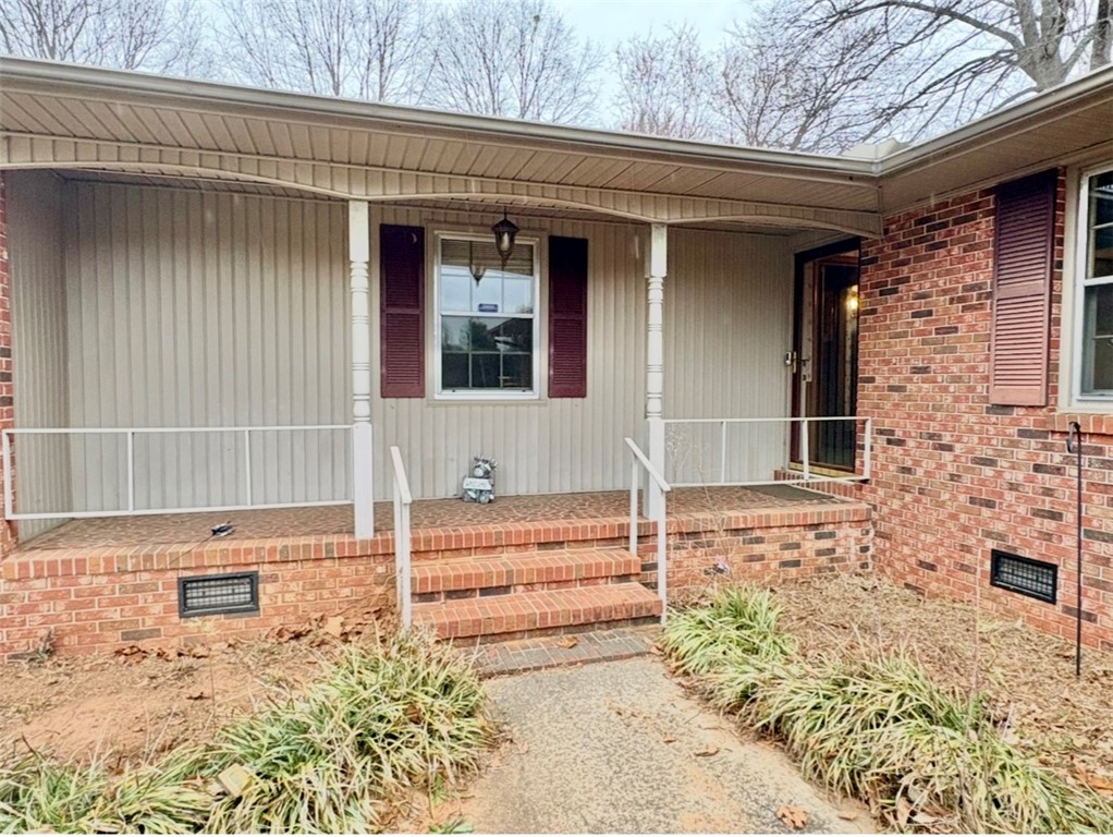 402 Loblolly Drive Anderson, SC 29625 - Photo 3 of 43 This charming home offers a welcoming facade with classic brick accents and a covered front porch.
