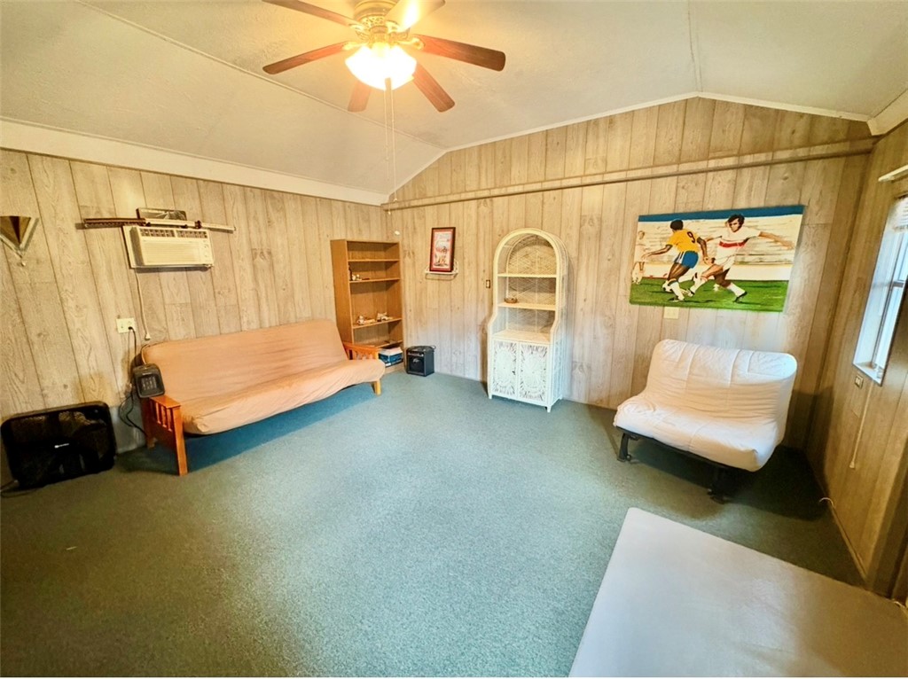 402 Loblolly Drive Anderson, SC 29625 - Photo 33 of 43 This versatile room features warm paneling and comfortable carpet, offering a cozy retreat for various uses.