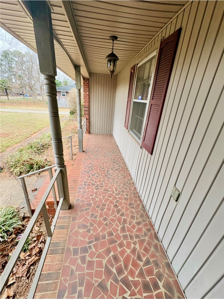 402 Loblolly Drive Anderson, SC 29625 - Photo 4 of 43 This inviting porch offers a warm welcome with its distinctive tiled flooring and classic architectural details.
