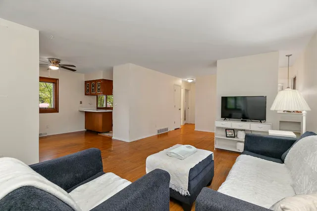 a view of kitchen with stainless steel appliances cabinets and wooden floor