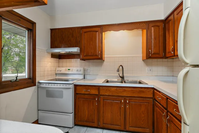 a kitchen with stainless steel appliances granite countertop a sink and cabinets