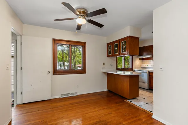 a view of a workspace with furniture and a window
