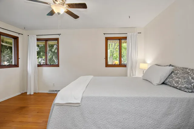 an empty room with windows and entrance to other room