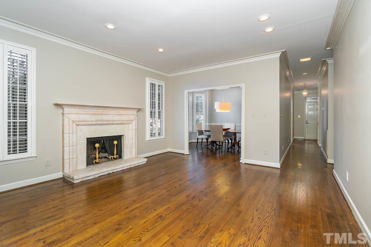 2625 Ashland Street Raleigh, NC 27608 - Photo 12 of 26 a view of a livingroom with wooden floor and a fireplace