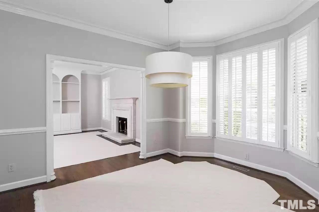 2625 Ashland Street Raleigh, NC 27608 - Photo 5 of 26 a bedroom with a bed and a chandelier